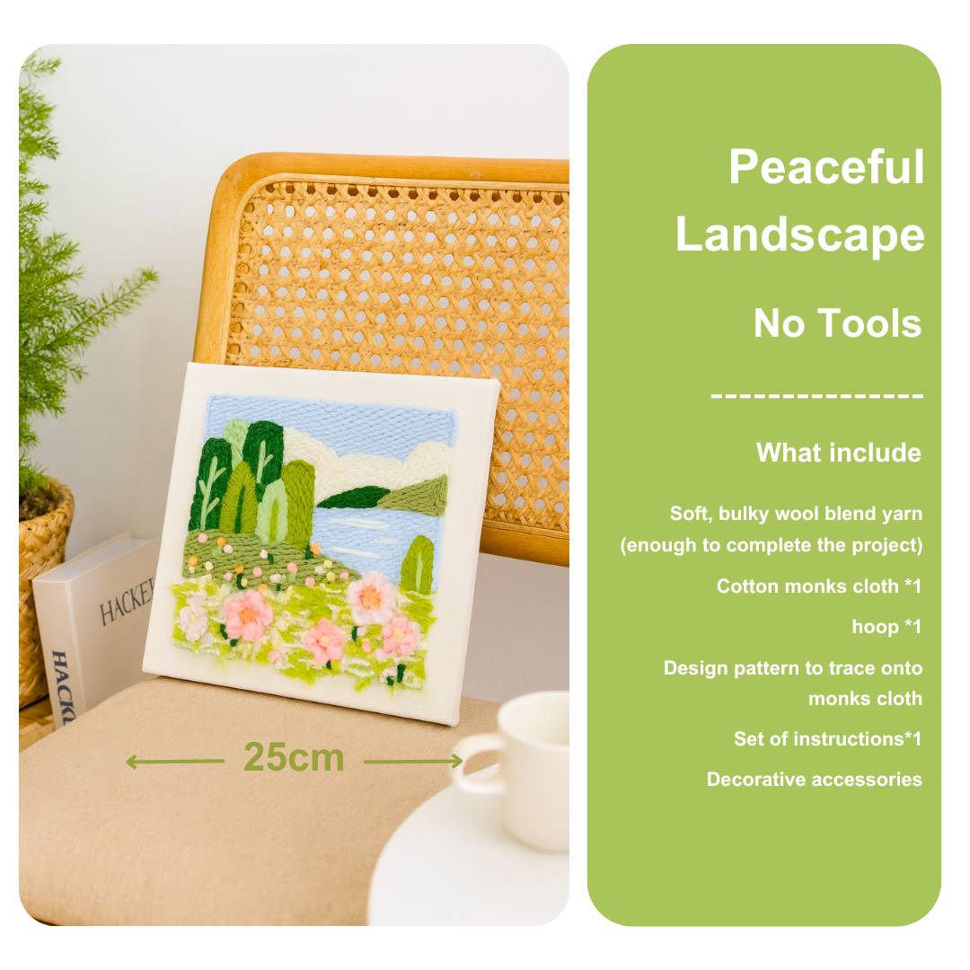 Punch needle embroidery kit with a landscape design on a table next to a chair, with product details on a green label.