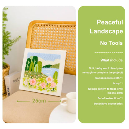 Punch needle embroidery kit with a landscape design on a table next to a chair, with product details on a green label.