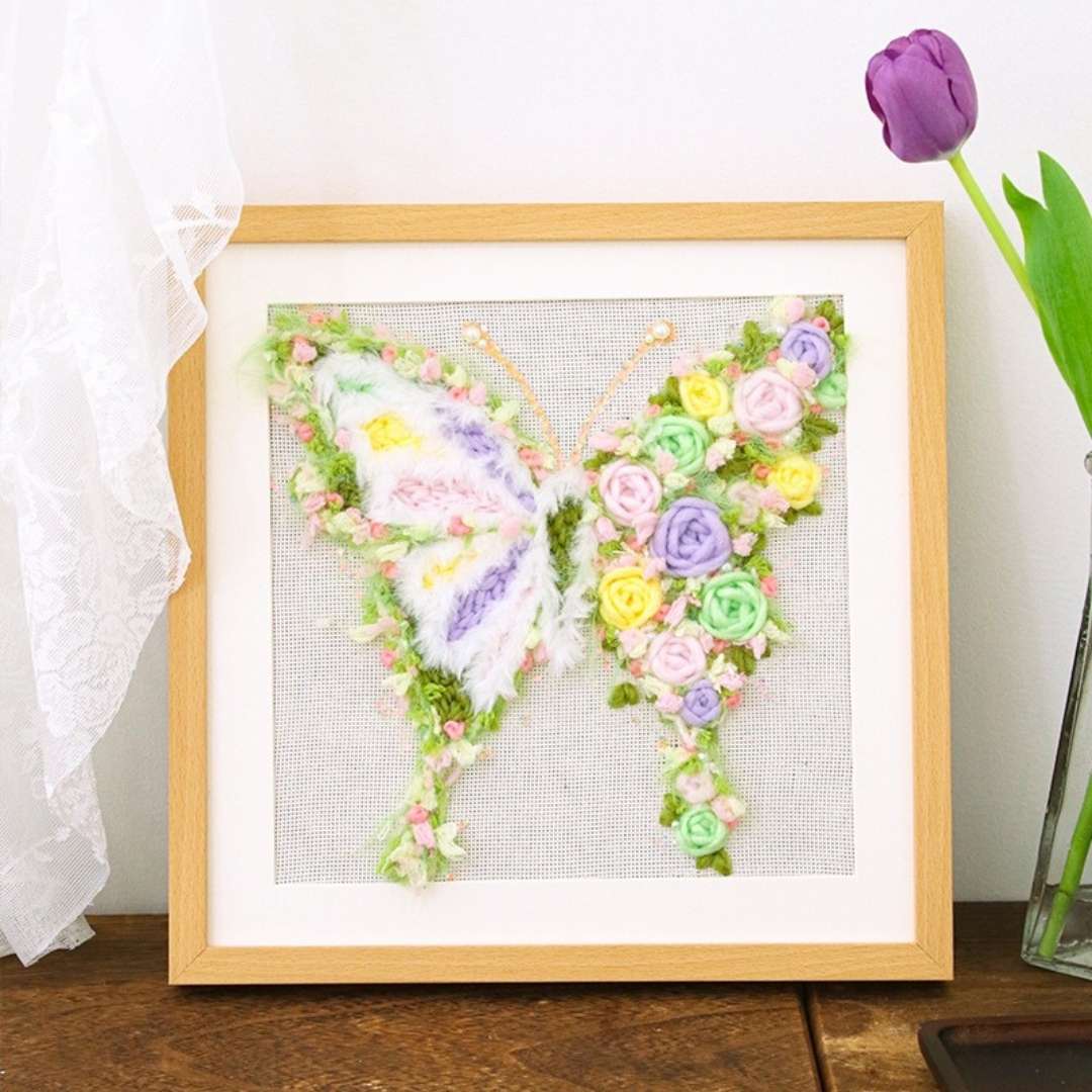 Puddingcase punch needle kit featuring a butterfly design adorned with colorful floral details, ideal for DIY embroidery crafts and home decor.