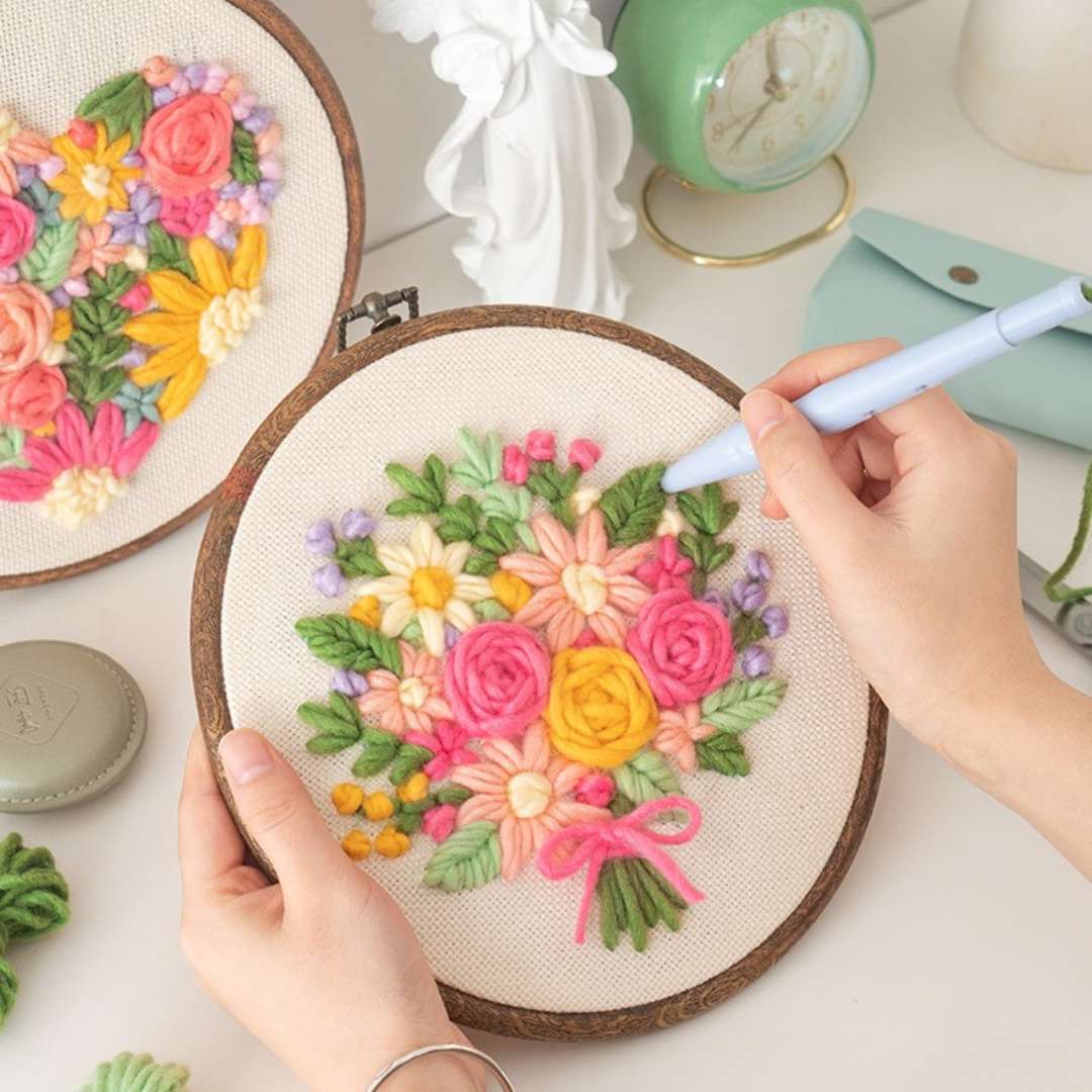 Puddingcase punch needle kit featuring a flower bouquet embroidery design in a wooden hoop, ideal for DIY crafts and beginners