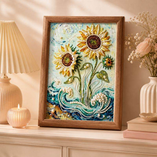 Framed sunflower pearl painting with golden blooms and blue waves on a shelf